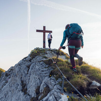 Rosskopf via ferrata Two women who are enthusiastic about mountain sports enjoy the morning atmosphere at the Rosskopf via ferrata in the Rofan mountains.
