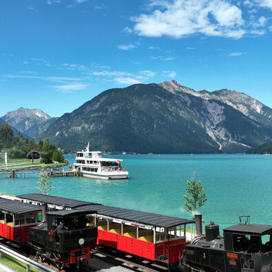 Train and ship at Lake Achensee The aerial view shows an Achensee boat and the Achensee railway at the Seespitz landing stage in summer.