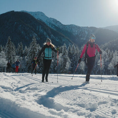 A woman takes part in the Achensee cross-country skiing camp (classic) in the snow-covered Karwendel valleys in glorious weather.