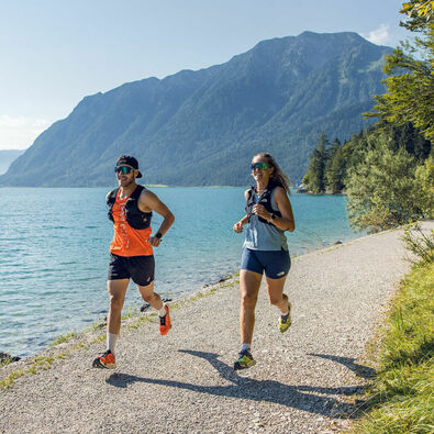 Running at Lake Achensee Two runners in beautiful summer weather on the shore of Lake Achensee.