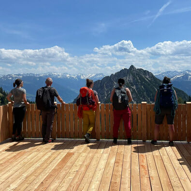 Climbing enthusiasts will find numerous routes at Lake Achensee. A small group is enjoying the view.