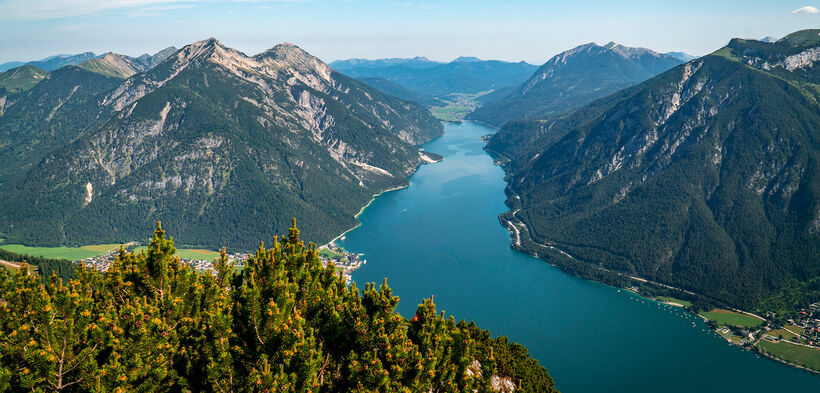 View from the Bärenkopf over Lake Achensee The Bärenkopf in the Nature Park Karwendel affords spectacular views of Lake Achensee and its surrounding villages.