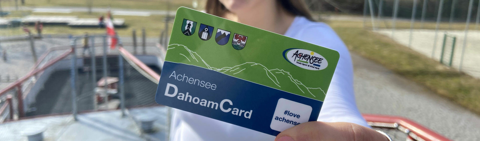 /// This photo captures a woman holding the Achensee region's benefit card for employees.